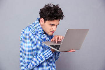 Angry man using laptop