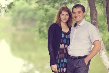 Young couple hugging in the park summer