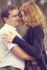 Young couple hugging in the park summer