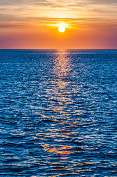 Fototapeta sunset at sea with multiple color prizm