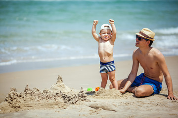 father and son build sand castle