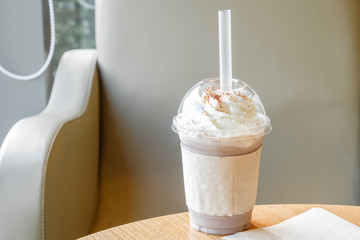 Ice chocolate frappe and whipped cream in the takeaway plastic cup