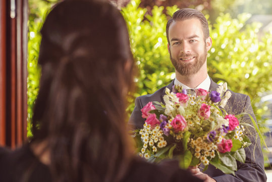 Handsome Guy Gives Fresh Flowers to his Girlfriend