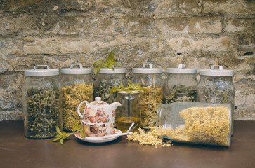 Herbs in Pots with Tea Set on Brick Wall background