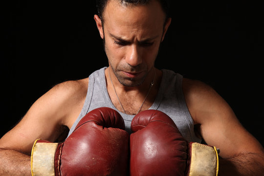 Male boxer isolated on black. 