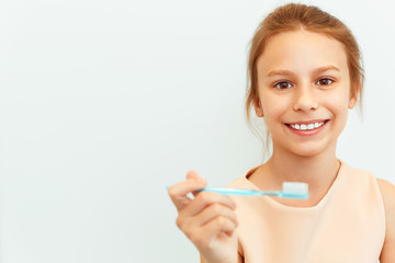 Little girl holding Teeh Brush.  Happy girl brushing her teeth