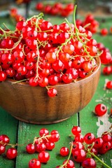 ripe fresh organic red currants in a wooden bowl closeup
