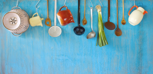 hanging vintage kitchen utensils and a bunch of green onions