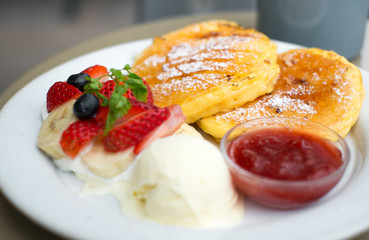 Obraz na płótnie Canvas traditional pancakes with strawberries jam and vanilla ice cream, selective focus pancake