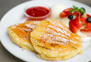traditional pancakes with strawberries and vanilla ice cream, selective focus pancake