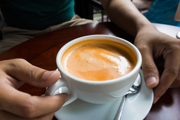 hand holding a cup of coffee hot drink design