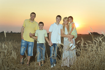 Family having rest in field