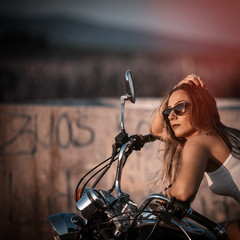 Fototapeta na wymiar Beautiful woman on the motorcycle. Retro filter