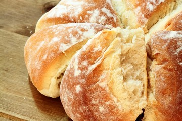 Bread.
Fresh homemade loaf of bread on wooden background.