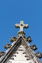 Fototapeta na wymiar Stone cross on roof of tomb