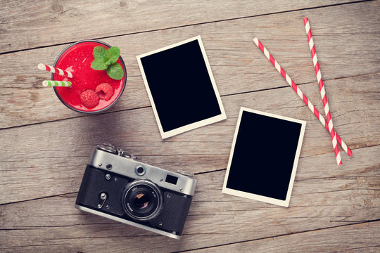 Camera, photo frames and raspberry smoothie
