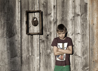 Boy with wooden walls. Frame, old padlock