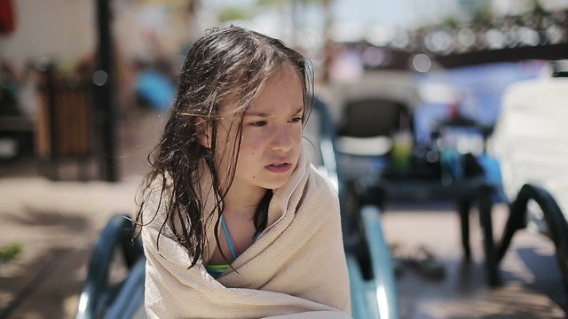 Child in a towel after a cold pool