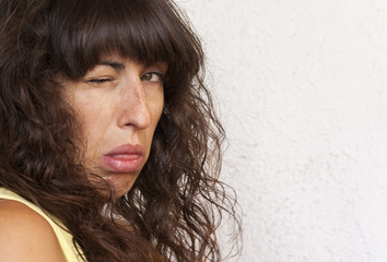 Beautiful young woman with a puzzled and funny face