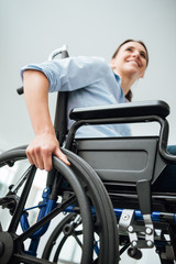 Obraz premium Smiling young woman in wheelchair