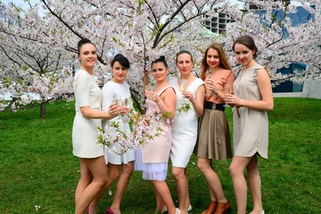 Girls with champagne celebrating in sakura's garden.
