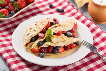 Delicious pancakes with raspberries, blueberries and strawberrie