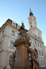Fototapeta na wymiar Statue of John of Nepomuk and the town hall in Prudnik