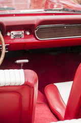 Red leather interior detail of retro classic sports vintage car 