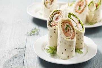 Mix of wraps with ham, chicken, salmon and crab served - obrazy, fototapety, plakaty