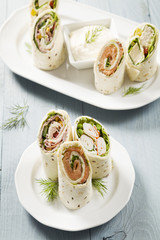 Mix of wraps with ham, chicken, salmon and crab served
