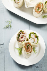 Mix of wraps with ham, chicken, salmon and crab served