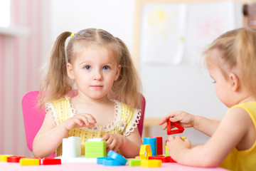 Obraz na płótnie Canvas children play educational toys in preschool