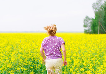Fototapeta premium Adult woman and colza