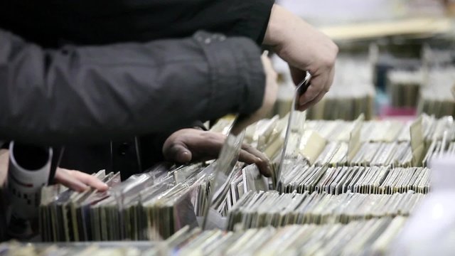 Buyers are choosing old vinyl records in the shop 