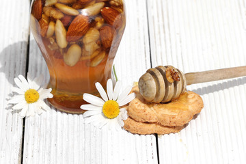 Honey in glass jars with flowers