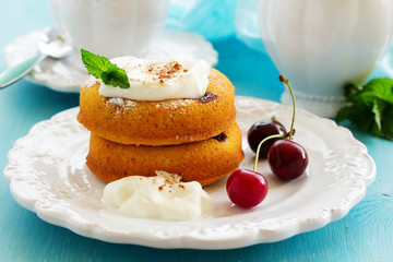 Clafoutis with cherries and whipped cream.