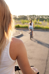 Young woman on bicycle on road