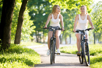 Two young women biking