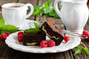 Brownie with raspberries and cheese filling.