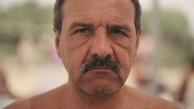 Portrait of an evil man with a mustache, with iron teeth. Close up