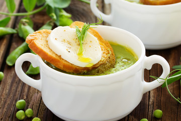 Green pea soup with croutons and cheese.