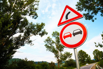 No overtake and three-cornered right turn sign