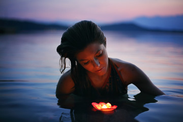 Beautiful woman with floating candle