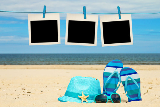 blank instant photos hanging on clothesline at the beach