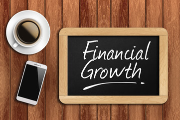 coffee, phone  and chalkboard with  word financial growth