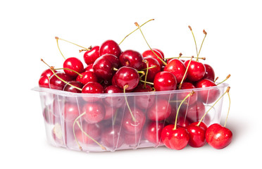 Fototapeta na wymiar Red sweet cherries in plastic tray rotated and three near
