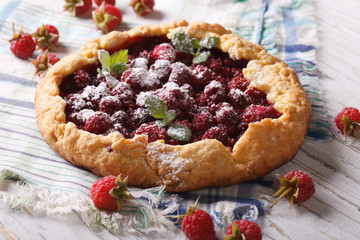Summer raspberry pie with mint close up on the table. horizontal
