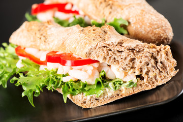 Prawn sandwich on black plate macro