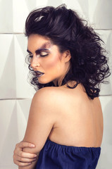 Fototapeta na wymiar High fashion art look fantasy. Beauty portrait of glamour sexy stylish brunette young woman model with amazing sparkle black makeup, healthy curly hair and fresh skin