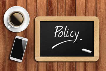 coffee, phone  and chalkboard with  word policy